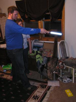 Titus plays a Star Wars game with a light saber.