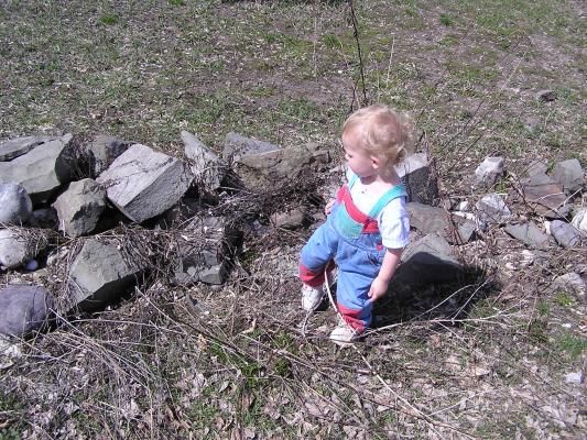 Noah goes hiking by some rocks.