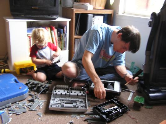 David and Noah take apart a broken stereo.