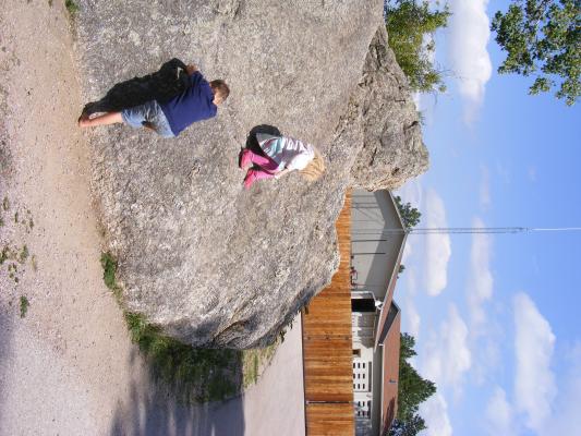 Noah and Sarah climb rock.