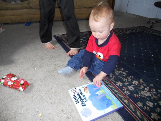 Joshua looks at his new book. 