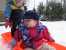 Sarah and Noah play in the orange sled. thumb