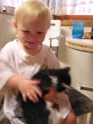 Sarah hold the kitten at Grandma Cline's house