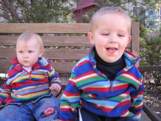 Sarah and Noah in the colorful sweaters on the bench.