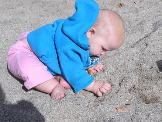 Sarah plays in the sand.