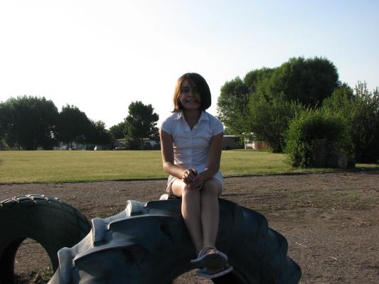 MAlia on a tire at the park.