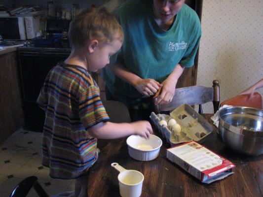 Noah helps bake a cake.