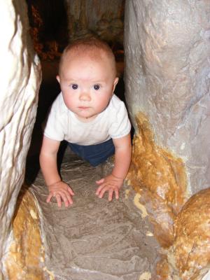Josh is serious about crawling through the cave.