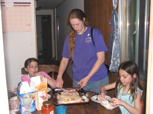 Katie serves cake to Malia and Andrea