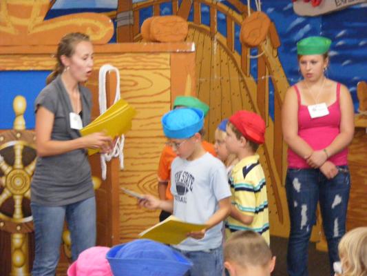 Katie G. gives out VBS awards to her group.