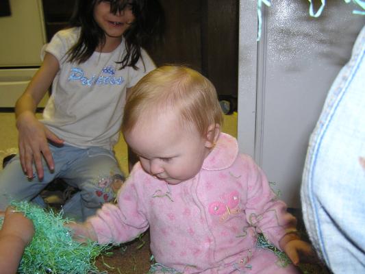 Sarah plays with Easter grass.