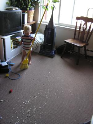 Noah sweeps up the spilled popcorn.