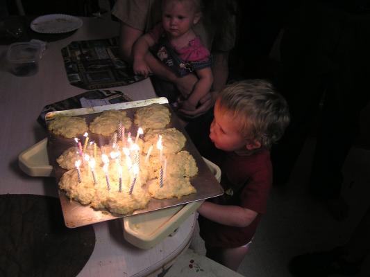 Noah helps blow out the candles on the shortcakes
