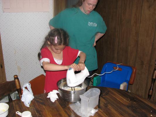 Andrea mixes a cake up for Katie.