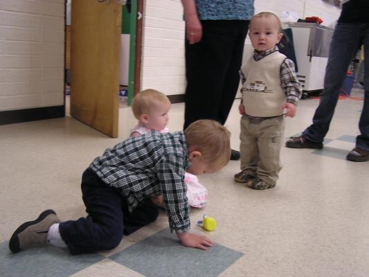 Noah, Sarah and Michael play on the floor.