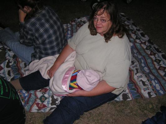 Mary holds Sarah at the fireworks show.