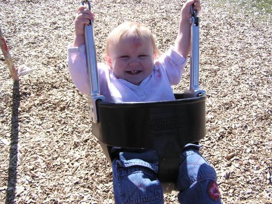 Sarah swings at the park.