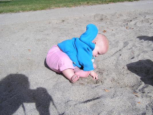 Sarah plays in the sand.