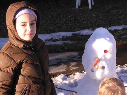 Malia wiht her snow person.