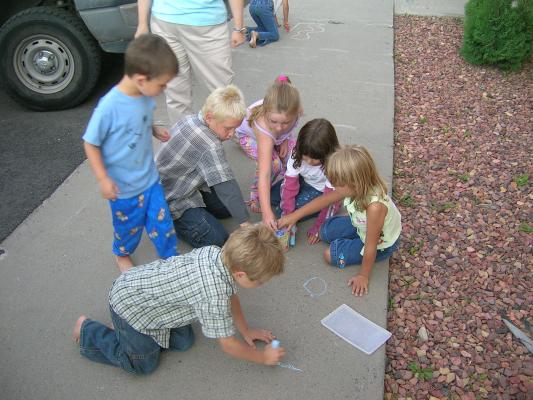 Drawing on the sidewalk with chalk at VBS Insomnia.