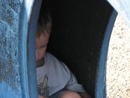 Noah in a tire at the park.