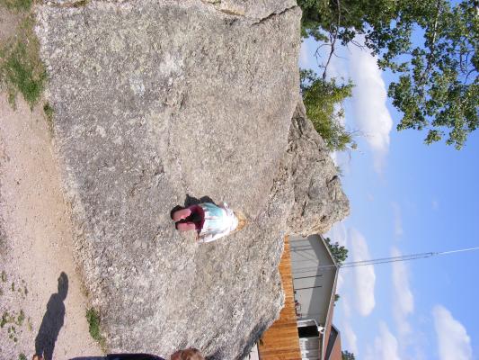 Sarah climbs rock.