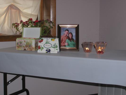 A nice table with a photo of Scott and Lindsay at Lindsay's bridal shower
