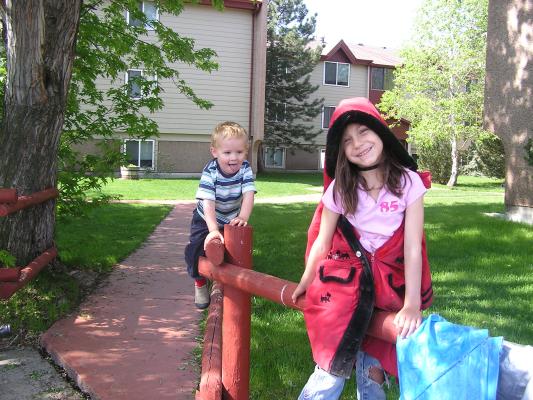 Noah and Andrea ride the horse fence.