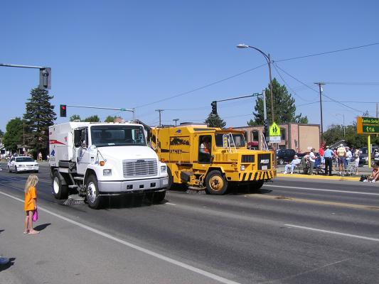 Street sweepers follow the Sweet Pea Festival Parade.