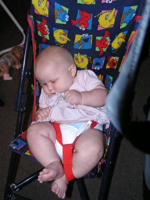 Sarah sits in her stroller.