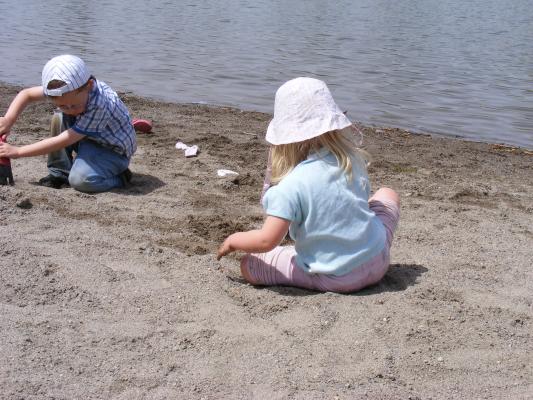 Noah and Sarah dig in the sand at Bozeman Pond.