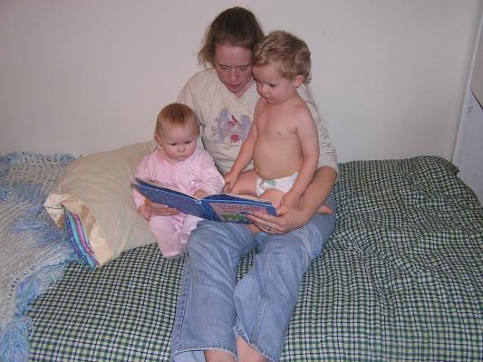 Sarah, Katie and Noah read a bedtime story.