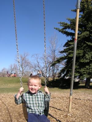 Noah swings at the park.