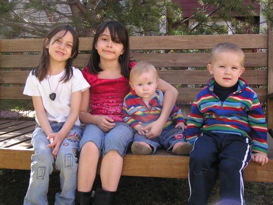 Andrea, Malia, Sarah and Noah on the bench; portrait.