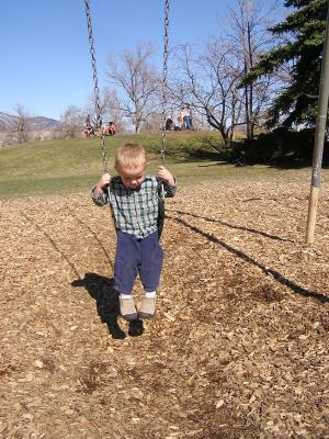 Noah swings at the park.