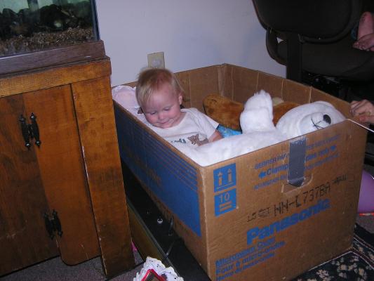 Sarah in a box of toys