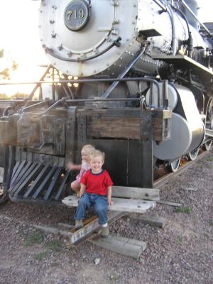 Noah and Sarah in front of an old steam engine