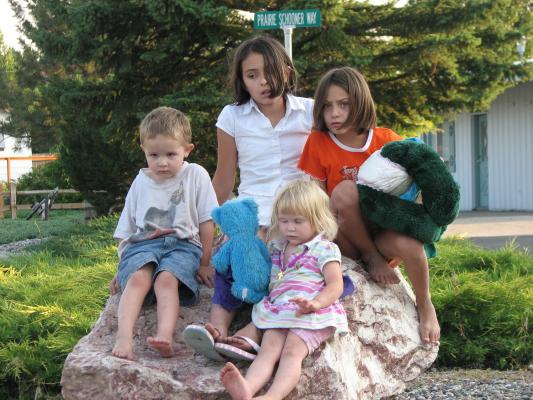 Noah, Malia, Andrea and Sarah.  on a rock.