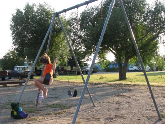 Andrea swinging at the Covered Wagon Mobile Home Park swing.