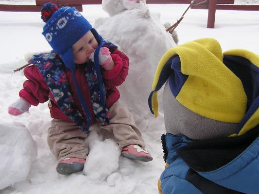 Sarah  and Noah play in the snow.