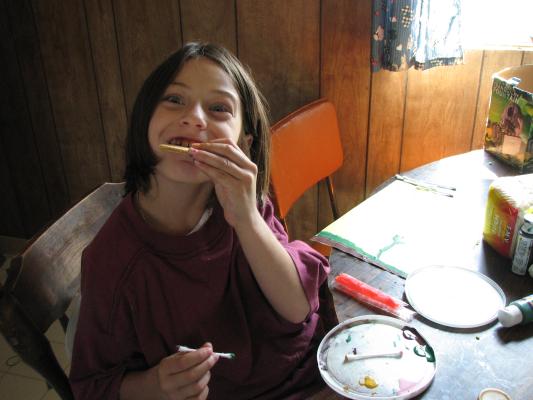 Andrea eats a cracker.