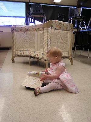 Sarah reads a book in the nursery.