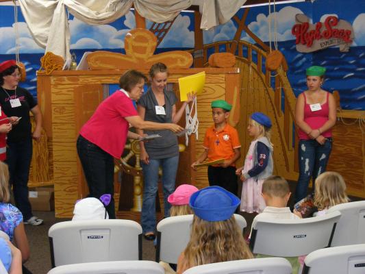 Deb and Katie G. giveing out VBS awards.