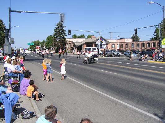 The Sweet Pea Festival Parade starts with a police motorcycle.