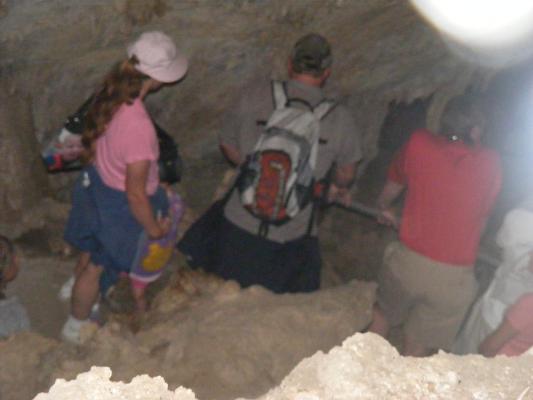 Katie, Sarah, and some strangers decend into the cave.