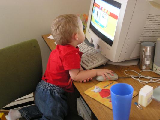 Noah is playing Curious George on the computer.