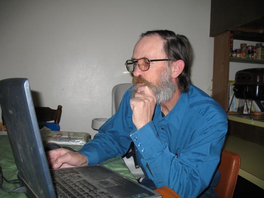 Robert plays with his laptop computer.