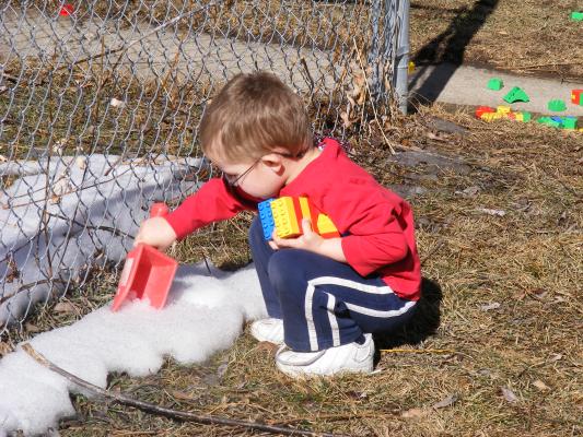 Noah digs in what is left of the snow.