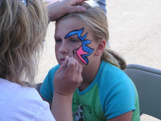 Kim paints Breeanna's face at the VBS carnival.