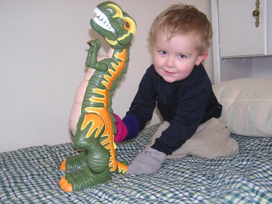 Noah plays with a  dinosaur